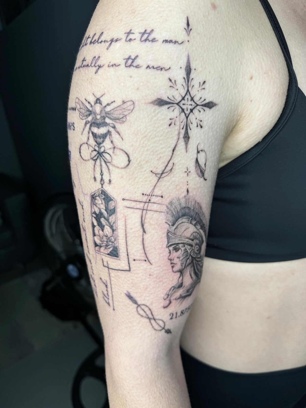 Fineline patchwork tattoo of a bee, compass, Athena and flower on a shoulder